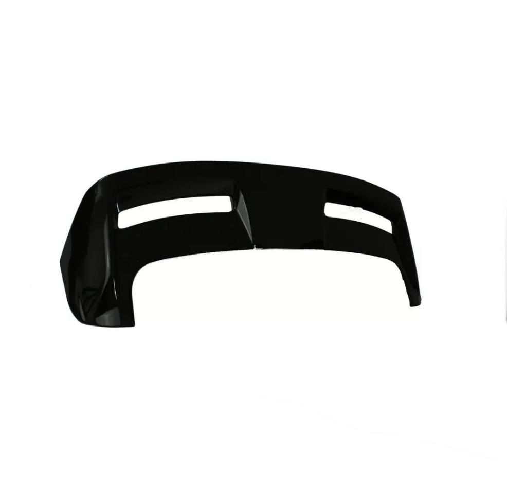 A glossy black car bumper, featuring two horizontal openings, rests against a plain white background, emphasizing its sleek, aerodynamic design.