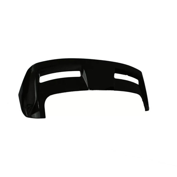 A glossy black car bumper, featuring two horizontal openings, rests against a plain white background, emphasizing its sleek, aerodynamic design.