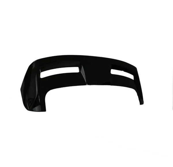 A glossy black car bumper, featuring two horizontal openings, rests against a plain white background, emphasizing its sleek, aerodynamic design.