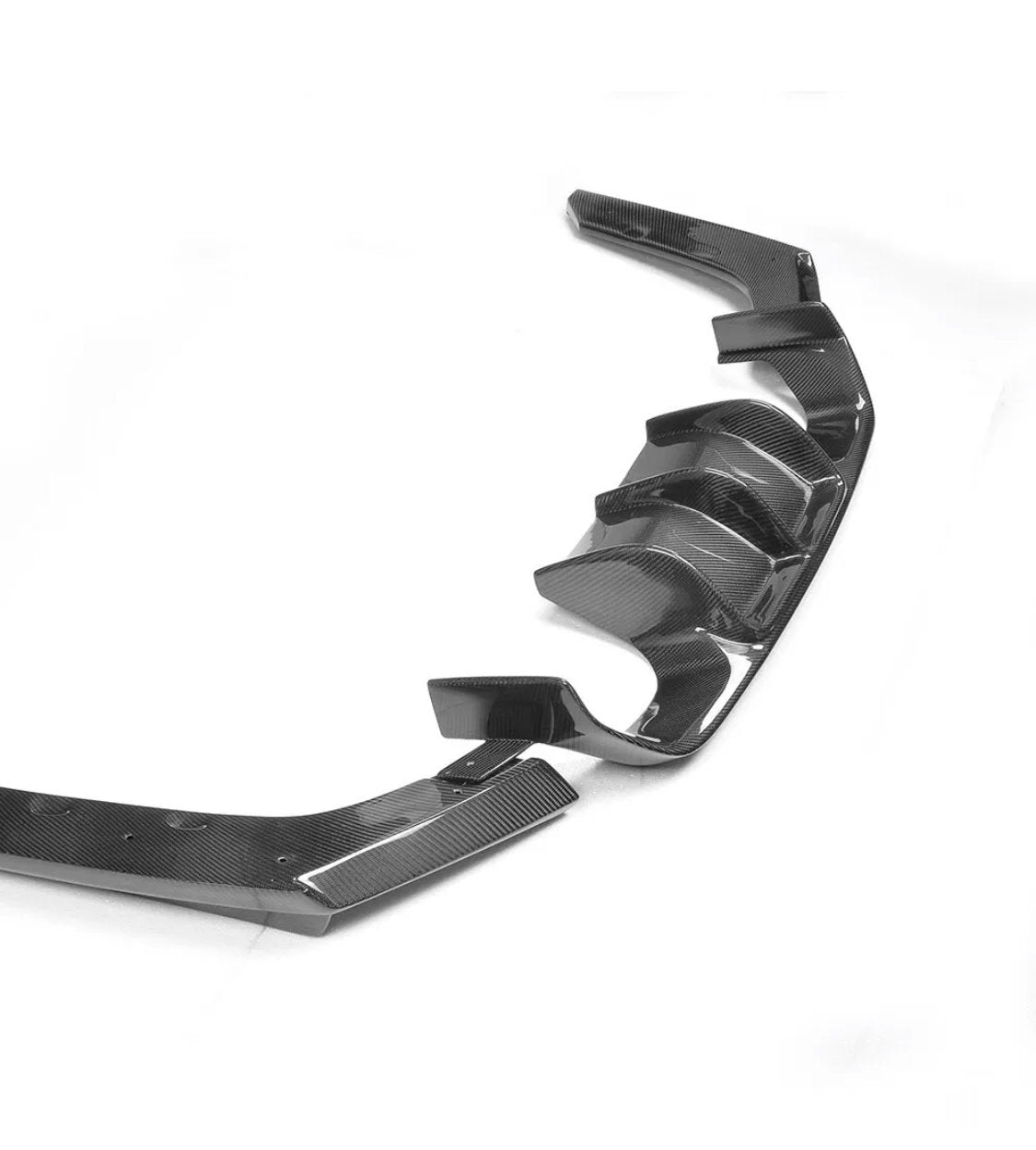 Carbon fiber car rear diffuser with multiple fins and curved edges, displayed against a plain white background, emphasizing its sleek and aerodynamic design.