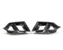Carbon fiber car exhaust tips with dual openings, facing each other on a plain white background.