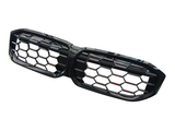 A dual-section car grille features a black hexagonal mesh design, positioned on a white background, suggesting automotive use.