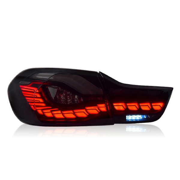 A sleek car taillight glows bright red with segmented LED patterns, featuring a small section of white LEDs, set against a plain white background.