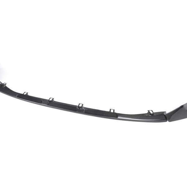 A glossy black car front splitter with mounting brackets displayed on a plain white background, showing its curved design and aerodynamic features.