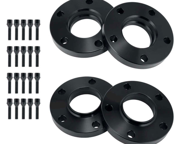 Four black circular wheel spacers with multiple bolt holes are arranged in pairs. Sixteen matching bolts are aligned vertically on the left side, indicating a set for automotive use.
