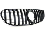 A glossy black car grille features vertical slats and an empty circular emblem holder, set against a plain white background.