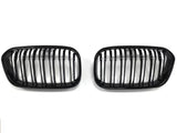Two black car grilles, each with vertical slats, are positioned side by side against a plain white background.
