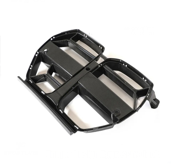 A black carbon fiber car grille, featuring multiple openings and a sleek design, rests on a plain white background.