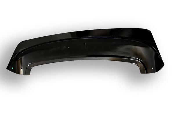 A glossy black plastic car fender lies on a white surface, with a slightly curved shape and a small reflective highlight on one corner.