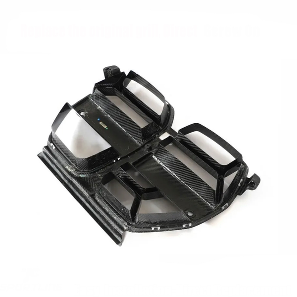 Carbon fiber car grille, angled forward, showing a sleek, black design with angular slats. Positioned on a white background, it appears ready for installation.