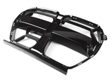 A glossy black car grill with bold lines and rectangular sections, oriented diagonally on a plain white background.