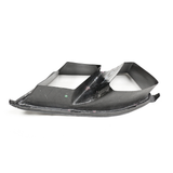Black carbon fiber panel with angular, aerodynamic design; rests on a flat surface, showcasing its lightweight structure and modern engineering.