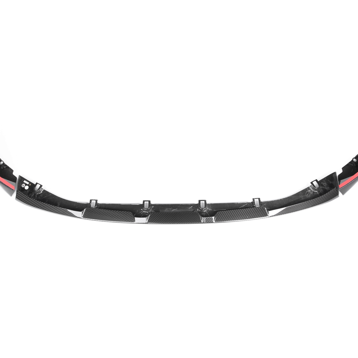 Black carbon fiber car front lip spoiler with aerodynamic design, featuring multiple mounting brackets and red accents. Positioned in a plain white background, highlighting its sleek structure.