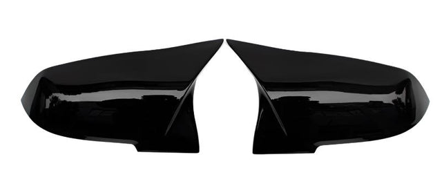 Two glossy black side mirror covers are positioned symmetrically, facing each other against a plain white background.
