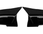 Two glossy black car mirror covers facing each other against a plain white background, highlighting their aerodynamic design.