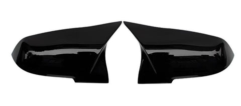 Two glossy black car mirror covers facing each other against a plain white background, highlighting their aerodynamic design.