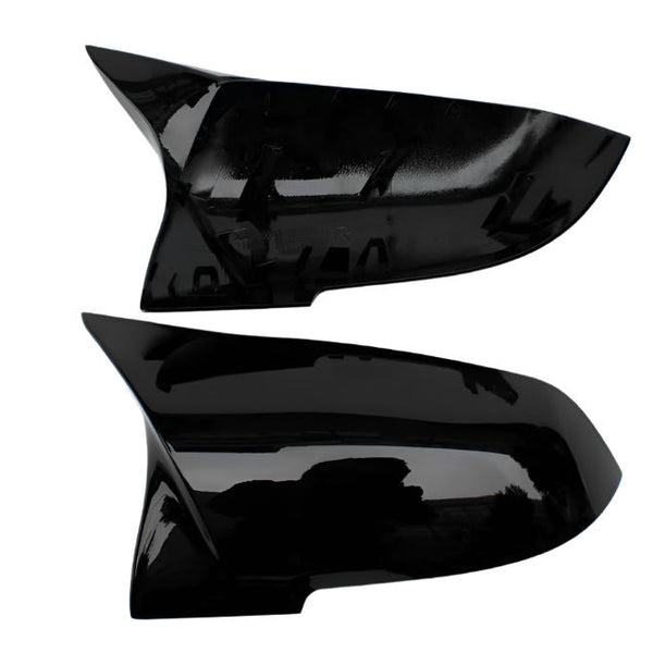 Two sleek black car side mirror covers are displayed horizontally against a plain white background. The covers have a glossy finish and aerodynamic design, suggesting a modern style.