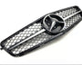 A black car grille features a central silver emblem with three pointed stars, bordered by a mesh pattern against a plain white background.