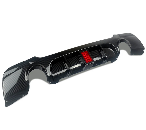 A black carbon fiber car bumper features a central red reflector, positioned on a plain white background, showcasing its sleek design and aerodynamic grooves.