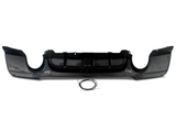 Black car bumper with aerodynamic design lying on a white background. A circular cable with exposed ends rests in front of the bumper.