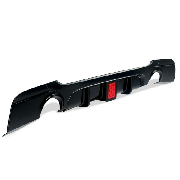 A black car bumper diffuser with red reflective elements is positioned against a white background, showcasing sleek, aerodynamic fins.