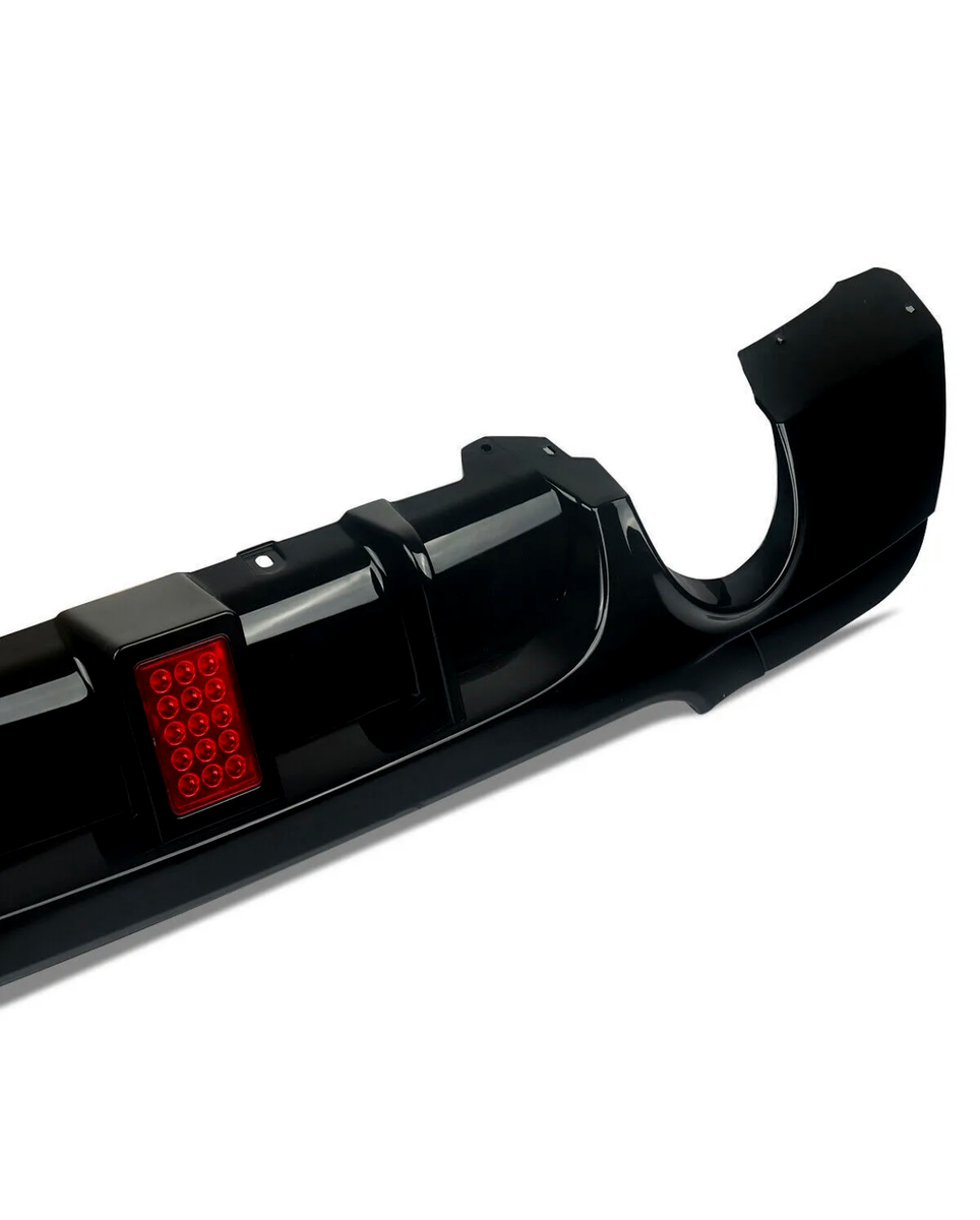 A black car bumper with a red rectangular section featuring twelve small circular lights, displayed against a plain white background.