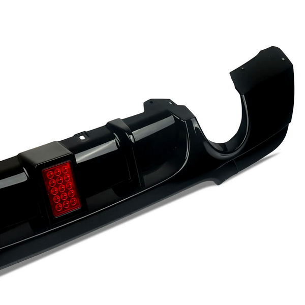 A black car bumper with a red rectangular section featuring twelve small circular lights, displayed against a plain white background.
