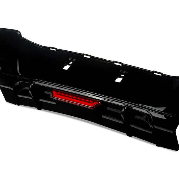 The object is a black car bumper with an integrated red reflector, resting on a white background. The design features cutouts for attachment, suitable for automotive enhancement.
