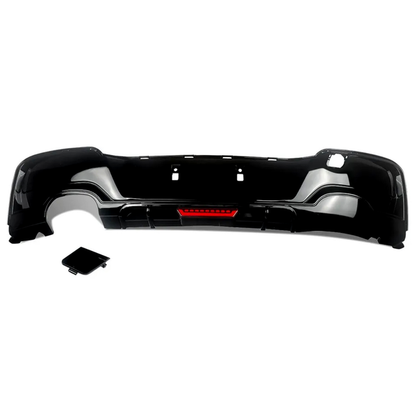 Black car bumper with a red reflector section, placed on a white background. A separate, matching black rectangular piece lies nearby, possibly a cover or attachment.