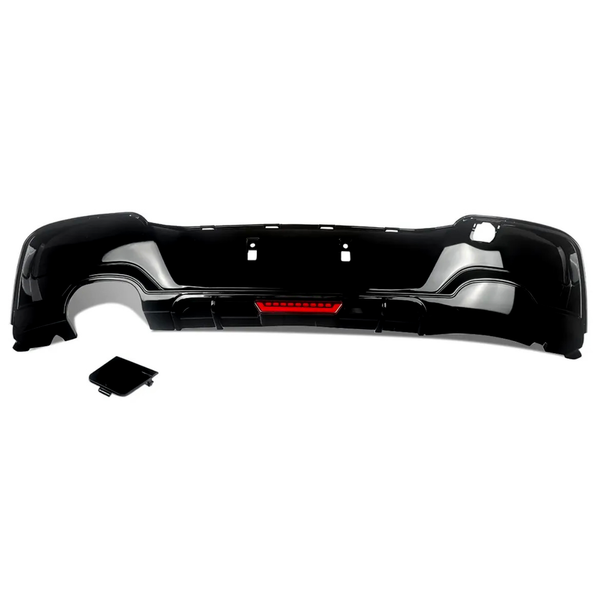 Black car bumper with a red reflector section, placed on a white background. A separate, matching black rectangular piece lies nearby, possibly a cover or attachment.