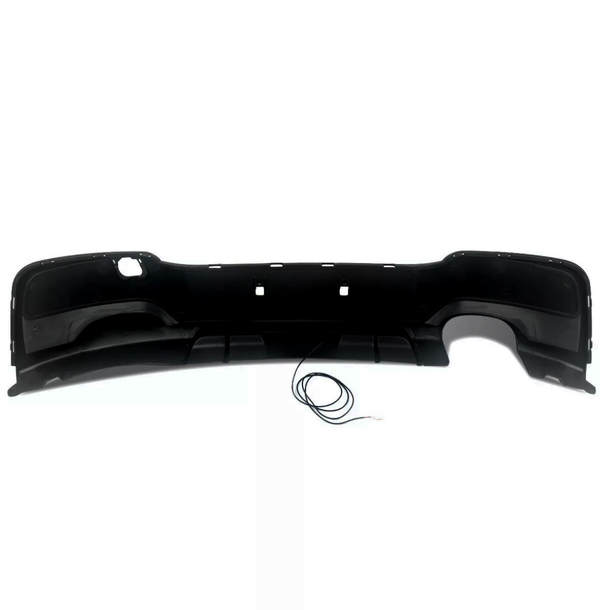 A black car bumper rests on a white background, featuring a curved shape with cutouts, and a thin cable lies coiled below it.