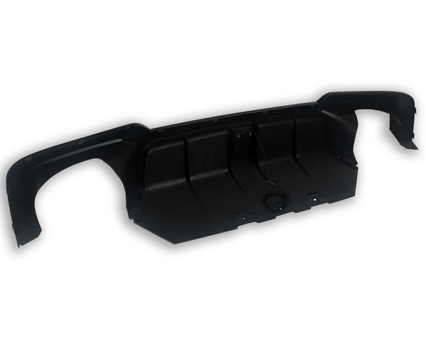 A black automotive bumper with a wired device attached, displayed on a white background. It is curved, suggesting it fits the rear of a vehicle, with mounting points visible.