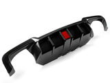 A carbon fiber car diffuser with a central red reflector. It features fins for aerodynamic purposes and is set against a plain white background, highlighting its sleek design.