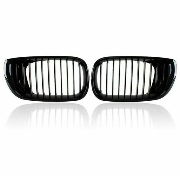 Two black car kidney grilles with vertical slats are shown against a plain white background, reflecting slightly underneath, suggesting a glossy surface.