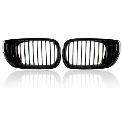 Two black car kidney grilles with vertical slats are shown against a plain white background, reflecting slightly underneath, suggesting a glossy surface.