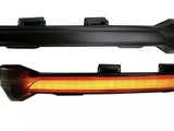 Two black automotive light fixtures are shown. The top fixture is unlit, while the bottom fixture emits a continuous amber glow. Both have mounting brackets and are isolated on a white background.