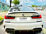 A white BMW 330i is parked on a sunny street. It features dual exhausts and displays the 