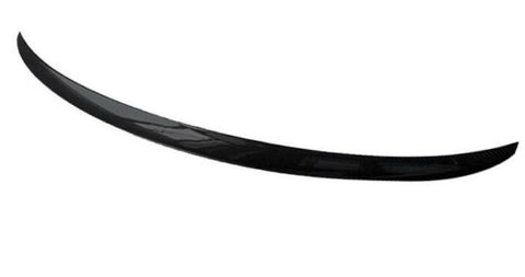 A sleek, black carbon fiber spoiler curves gracefully in a minimalist, white background.