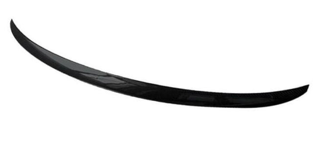 A sleek, black carbon fiber spoiler curves gracefully in a minimalist, white background.