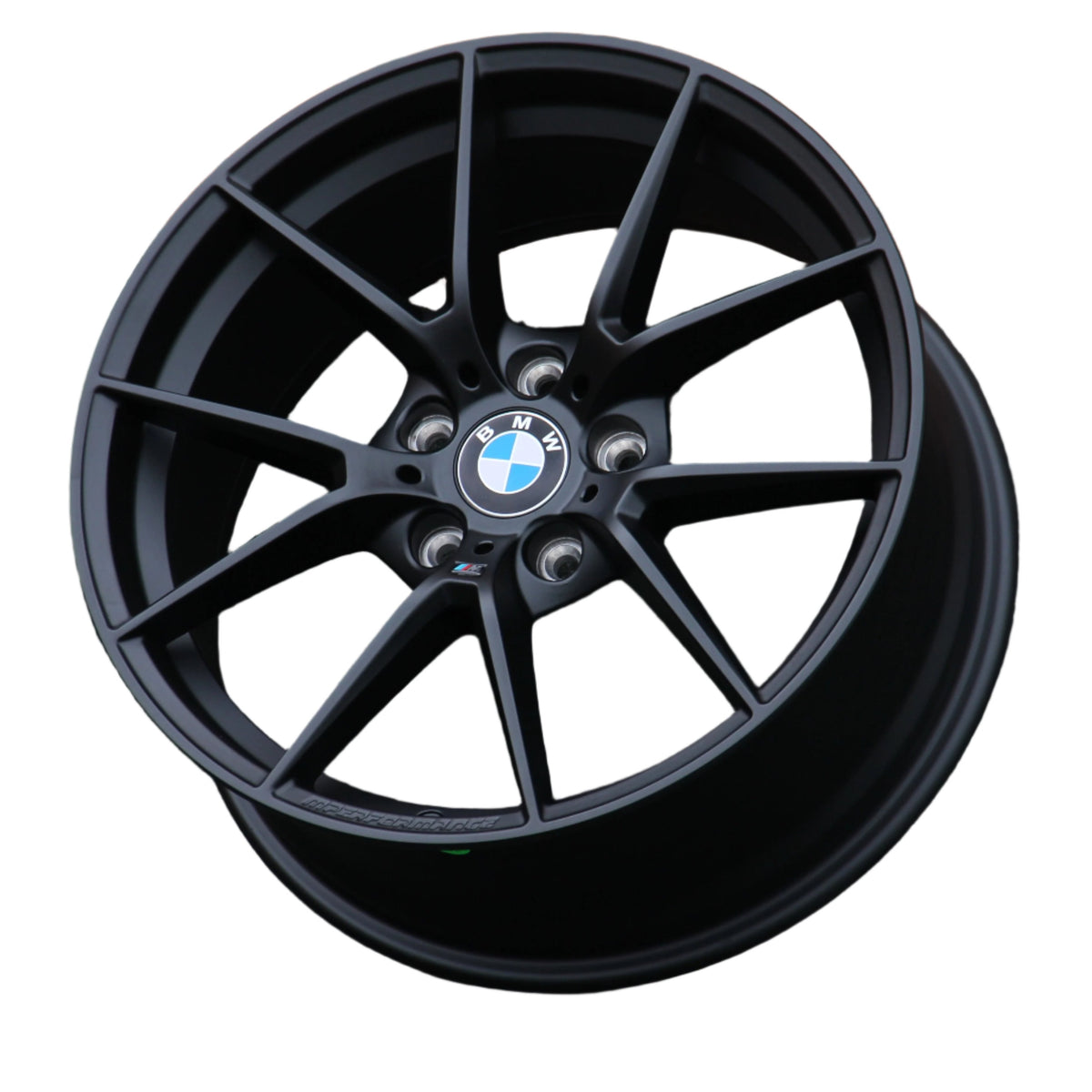 A black, multi-spoke BMW wheel rim with visible lug holes and a "BMW" center cap, displayed against a plain white background. Text on the rim reads "M Performance."