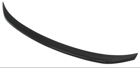 A black, curved car spoiler made of carbon fiber material is displayed against a plain white background.