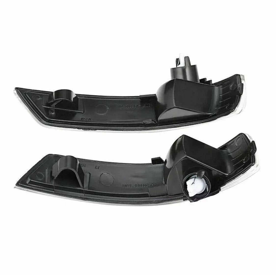 Two black car mirror indicators, each with a sleek curved shape and mounting clips, lie against a white background, showcasing their design and structure for automotive use.