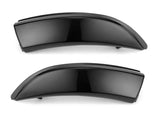 Two sleek, black car fender flares are displayed horizontally against a plain white background, highlighting their smooth, curved design and glossy finish.
