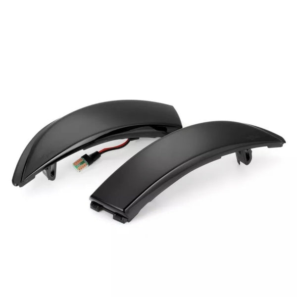 Two black curved LED indicator lights rest on a white background, each featuring a connected wire and plug, designed for automotive or motorcycle use as signal lights.