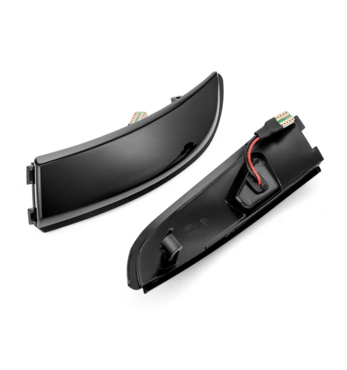 Two sleek, curved black car light covers rest side by side; one shows a red wire inside, set against a plain white background.