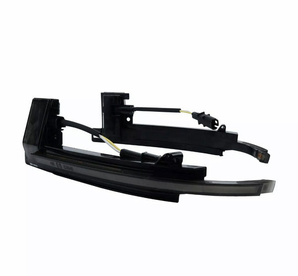 A pair of black LED car side mirror turn signal lights with attached wires rests against a plain white background.