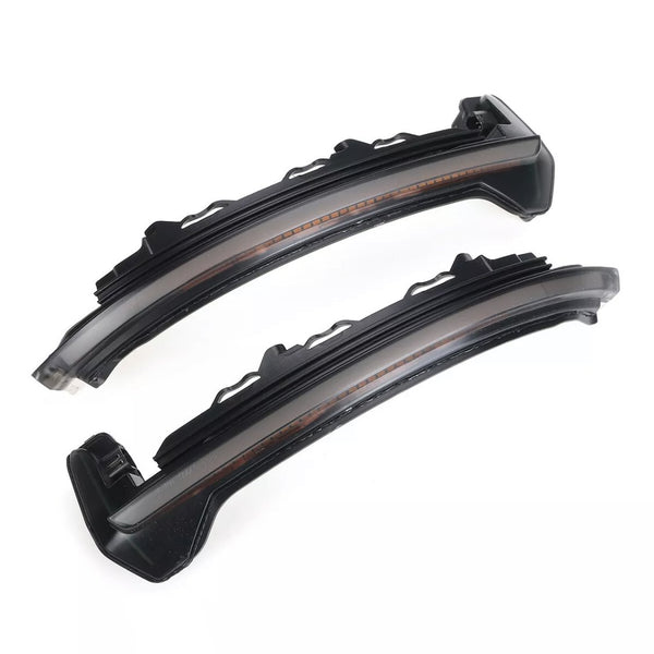 Curved LED light strips, unlit and black, rest against a white background, displaying mounting brackets on one side for automotive use.
