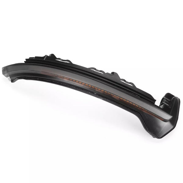 Curved black car part, likely a side mirror indicator light, with an orange strip inside. Placed on a plain white background, highlighting its sleek, aerodynamic design.