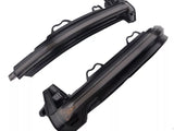 Two curved black LED car indicator lights rest side by side against a white background, featuring integrated connectors and mounting brackets for vehicle installation.
