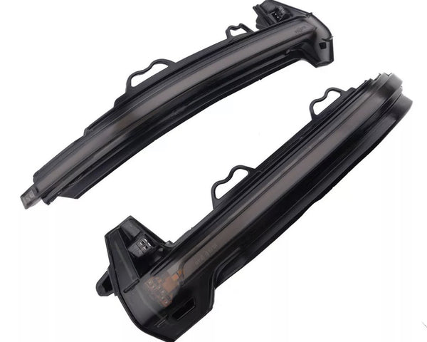 Two curved black LED car indicator lights rest side by side against a white background, featuring integrated connectors and mounting brackets for vehicle installation.